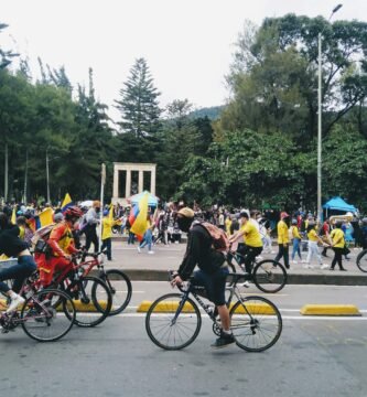 a group of people riding bikes down a street